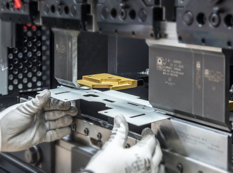 Sheet metal being fed into press brake machine
